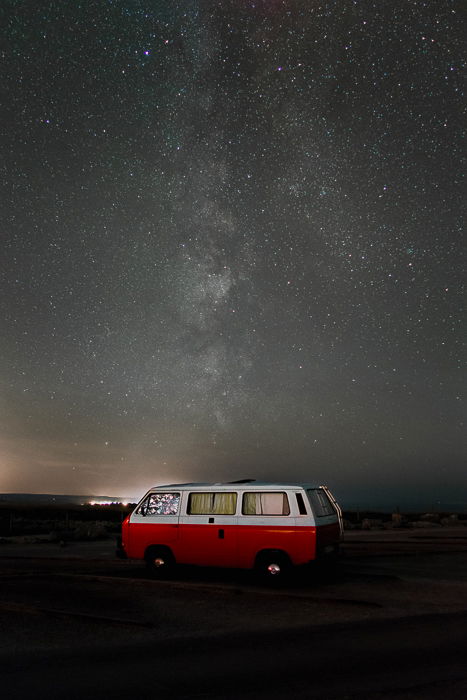 Image of a red camper van parked under an impressive starry sky after using focus <a target=